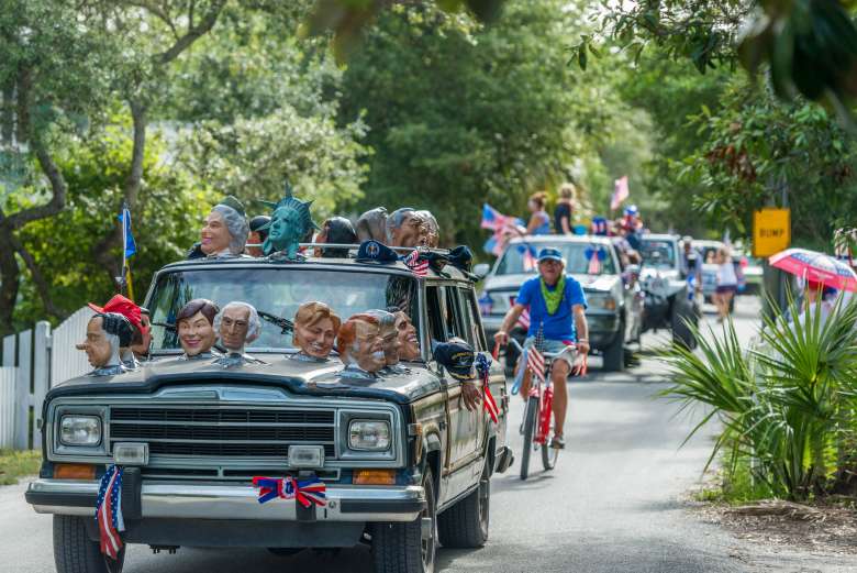 A caravan of cars and bicycles in Grayton Beach Florida on the 4th of July.