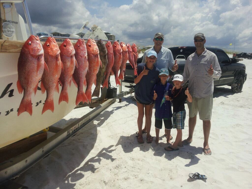 Fathers and sons show off their catch, thanks to Captain Phil Charters of 30A.