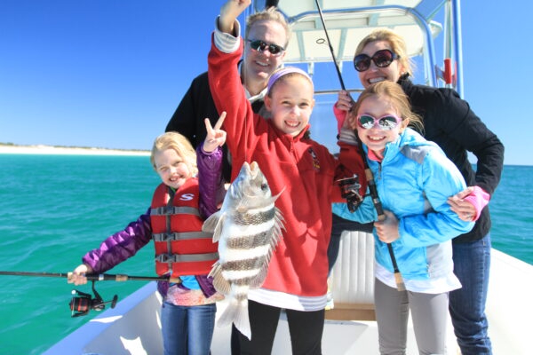 A family enjoys time with Shallow Water Expeditions, a kid-friendly fishing charters on 30A.