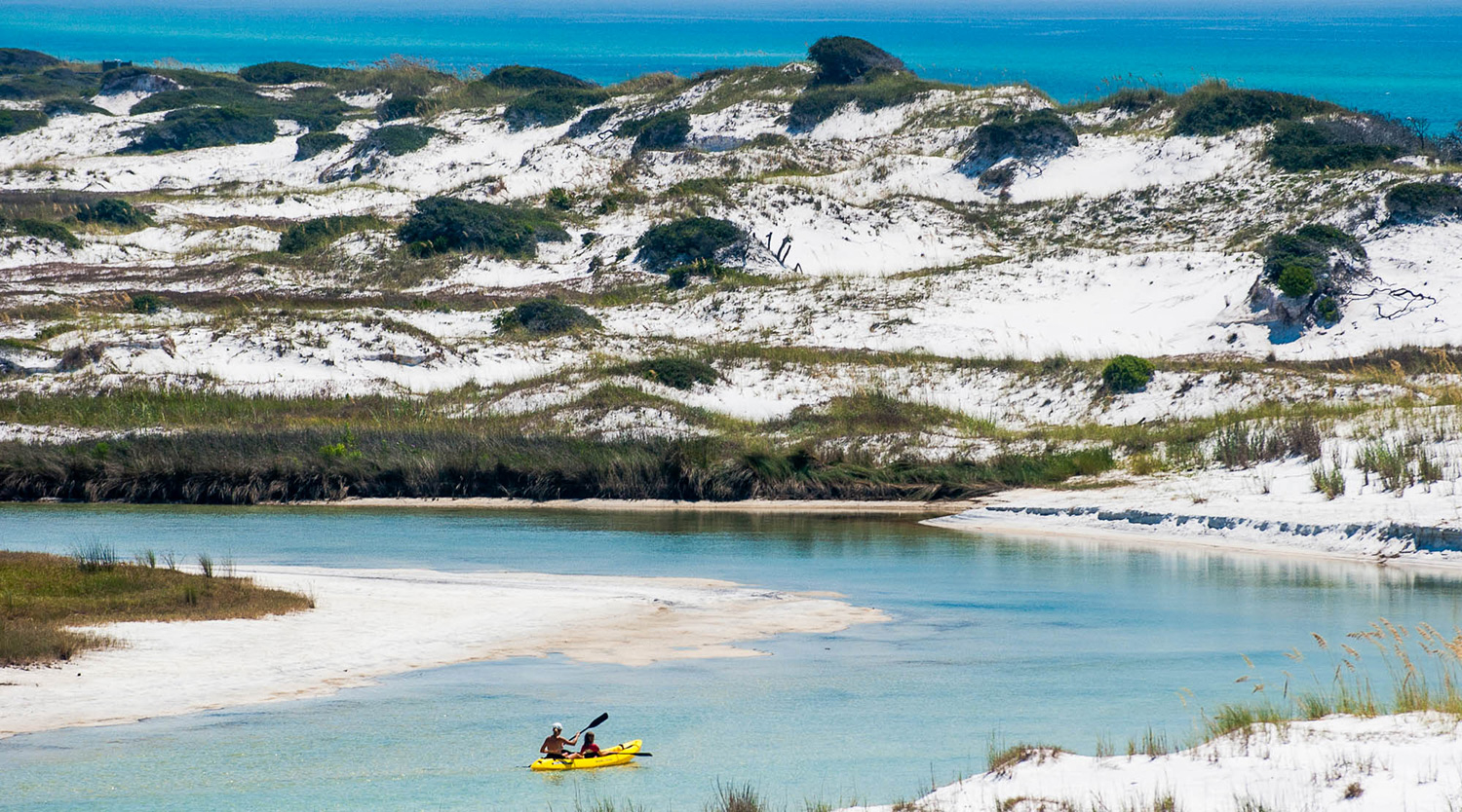 A couple enjoy paddling through the magnificence of Grayton Beach State Park.