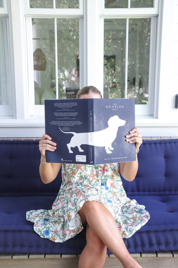 Girl enjoying book about 30A's unique Seaside style.